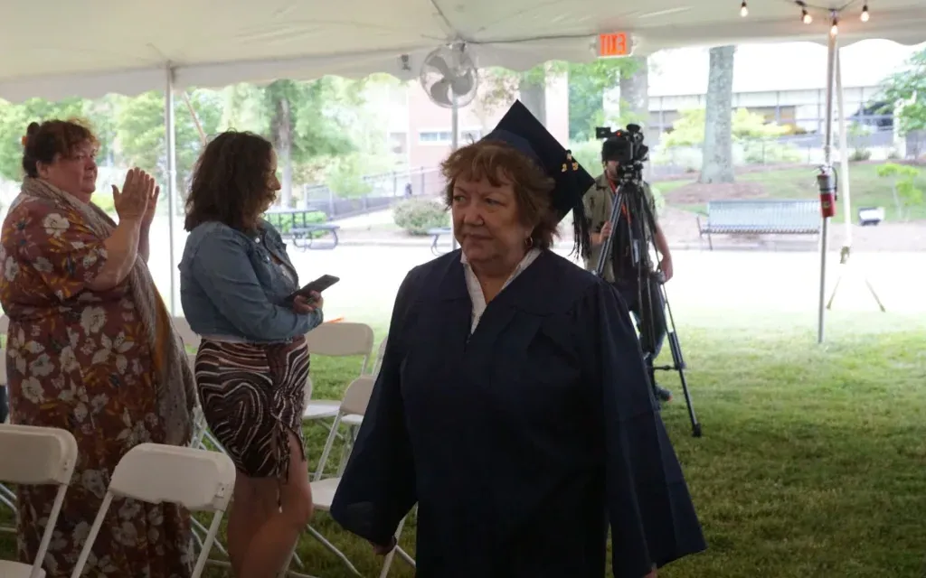 Female student in cap and gown at graduation